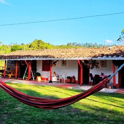 a hammock in front of a house at Casa De Campo 