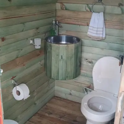 a bathroom with a toilet and a bath tub at Casa De Campo 