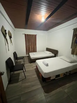 a room with two beds and a chair in it at Las 5 Quintas - Acogedora casa in San Rafael