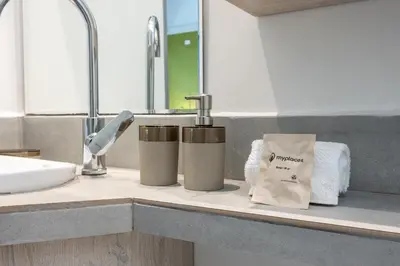 a bathroom counter with two trash cans and a sink at Contablers in Medellín