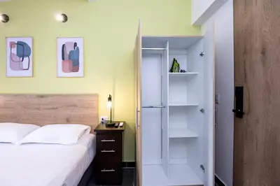 a bedroom with a bed and a glass door at Contablers in Medellín