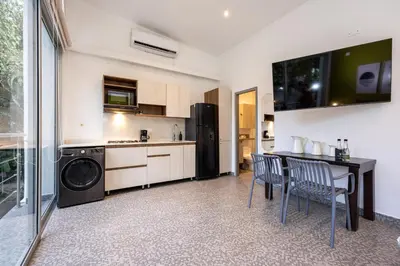 a kitchen with a table and chairs in a room at Contablers in Medellín