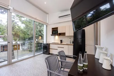 a kitchen with a table and chairs and a large window at Contablers in Medellín