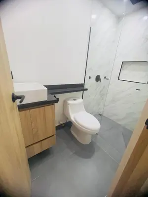 a bathroom with a toilet and a shower at Torre Meraki in Medellín