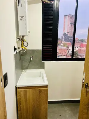 a bathroom with a sink and a window at Torre Meraki in Medellín