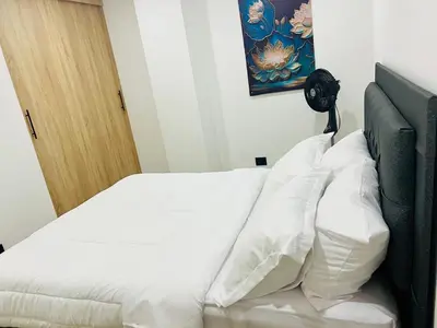 a bedroom with a bed with white pillows at Torre Meraki in Medellín