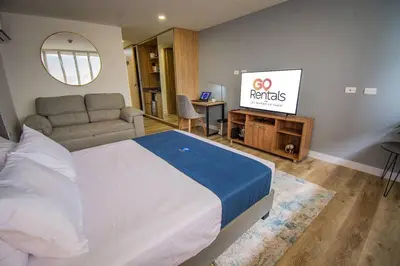a bedroom with a bed and a flat screen tv at TOP FLOOR Studio Poblado, A/C, Coworking, gym 1416 in Medellín