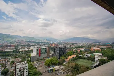 a view of a city with mountains in the background at TOP FLOOR Studio Poblado, A/C, Coworking, gym 1416 in Medellín