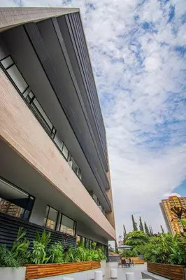 a large building with plants on the side of it at TOP FLOOR Studio Poblado, A/C, Coworking, gym 1416 in Medellín
