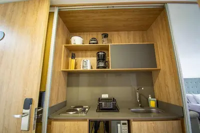 a small kitchen with a sink and a microwave at TOP FLOOR Studio Poblado, A/C, Coworking, gym 1416 in Medellín