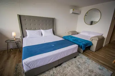 a bedroom with two beds and a mirror at TOP FLOOR Studio Poblado, A/C, Coworking, gym 1416 in Medellín