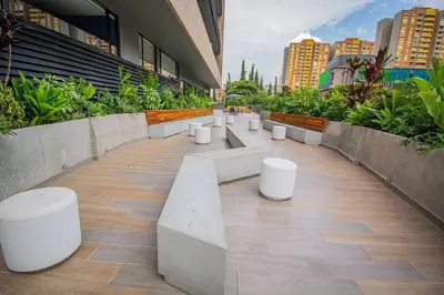 a row of white benches in a building at Bright Studio Topfloor A/C, Poblado Coworking1412 in Medellín