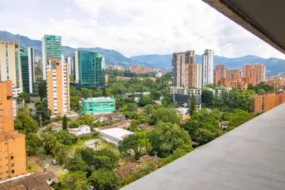 a view of a city with tall buildings and trees at Bright Studio Topfloor A/C, Poblado Coworking1412 in Medellín