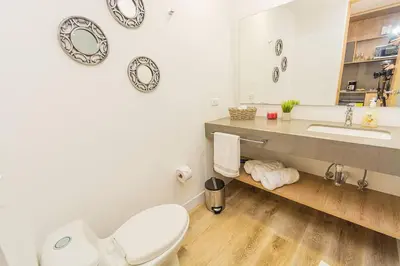 a bathroom with a toilet and a sink and a mirror at Bright Studio Topfloor A/C, Poblado Coworking1412 in Medellín