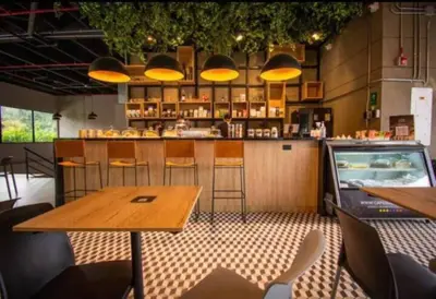 a restaurant with a table and a bar with yellow lights at Bright Studio Topfloor A/C, Poblado Coworking1412 in Medellín