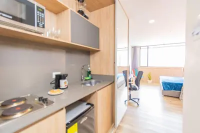 a kitchen with a counter top and a stove at Bright Studio Topfloor A/C, Poblado Coworking1412 in Medellín