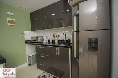 a kitchen with a stainless steel refrigerator at Cozy studio in Poblado, parking, NO FEE 1107 in Medellín