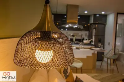 a light hanging from a table in a kitchen at Cozy studio in Poblado, parking, NO FEE 1107 in Medellín