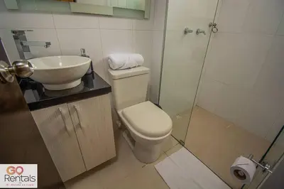 a bathroom with a toilet and a sink and a shower at Cozy studio in Poblado, parking, NO FEE 1107 in Medellín