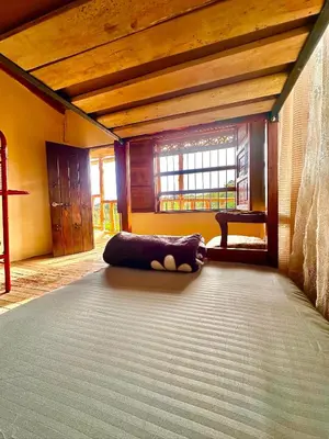 a room with a bed in the middle of a room at Wayra Ecolodge in El Peñol