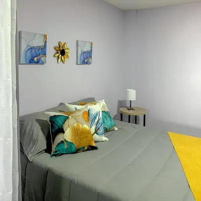 a bedroom with a bed with two pillows on it at Apartamento con tina para tu relax! Prime location in Manizales