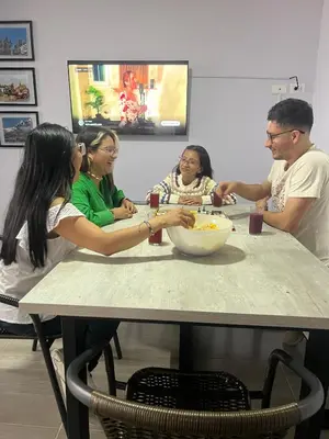 a group of people sitting at a table at Apartamento con tina para tu relax! Prime location in Manizales