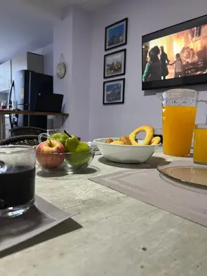 a table with bowls of fruit and a glass of orange juice at Apartamento con tina para tu relax! Prime location in Manizales