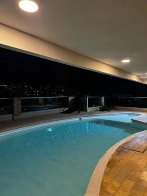 a swimming pool with a city skyline in the background at Blux 1305 Poblado Medellín Colombia in Medellín