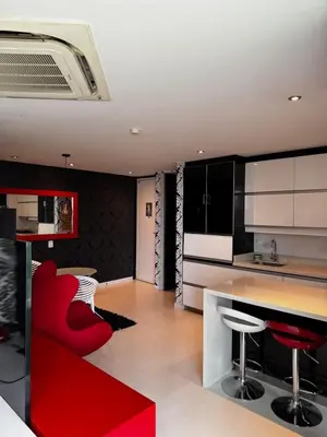a kitchen with black and white cabinets and red chairs at Blux 1305 Poblado Medellín Colombia in Medellín