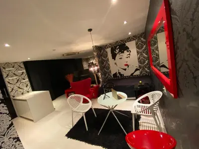 a room with red and white chairs and a table at Blux 1305 Poblado Medellín Colombia in Medellín