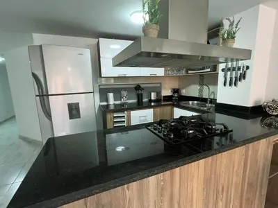 a kitchen with a black counter top with a stove at Comodo y amplio apartamento en Laureles in Medellín
