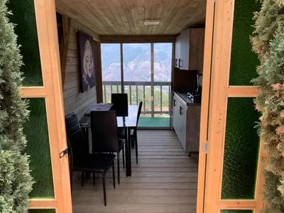 a kitchen and dining room with a table and chairs at Chalet El Pinal - Copacabana in Copacabana