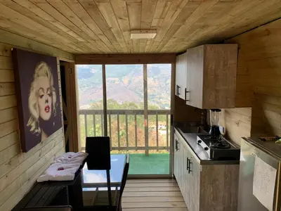 a kitchen with a table and a large window at Chalet El Pinal - Copacabana in Copacabana