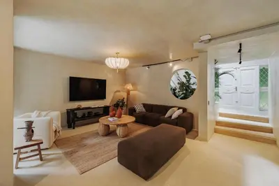 a living room with a couch and a table at Casa Selva, a unique luxury house in the heart of El Poblado in Medellín