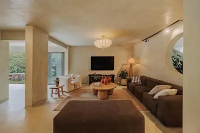 a living room with a couch and a table at Casa Selva, a unique luxury house in the heart of El Poblado in Medellín