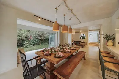 a dining room with a wooden table and chairs at Casa Selva, a unique luxury house in the heart of El Poblado in Medellín