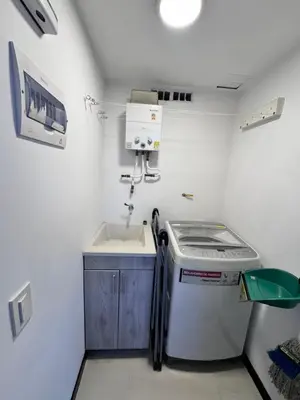a small kitchen with a sink and a washing machine at 2211 Despierta en poblado Medellín - Vista panorámica in Medellín