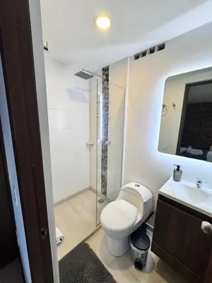 a bathroom with a toilet and a glass shower at 2211 Despierta en poblado Medellín - Vista panorámica in Medellín