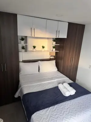 a bedroom with a bed with two towels on it at 2211 Despierta en poblado Medellín - Vista panorámica in Medellín