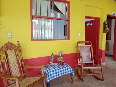 a room with chairs and a table and a window at Libélula finca-hotel in Concepción