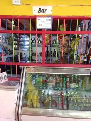 a store filled with lots of bottles of drinks at Libélula finca-hotel in Concepción