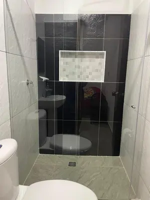 a bathroom with a glass shower with a toilet at Hotel Casa Azul in Sonsón