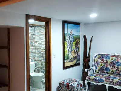 a room with a chair and a picture on the wall at Hotel Chalet en montaña Manizales in Villamaría