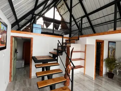 a set of stairs in a house with a roof at Hotel Chalet en montaña Manizales in Villamaría