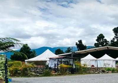 a group of tents with mountains in the background at Hotel Chalet en montaña Manizales in Villamaría