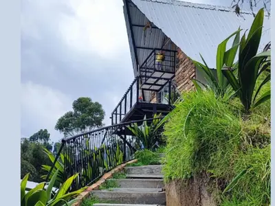 a stairway leading up to a house with a balcony at Hotel Chalet en montaña Manizales in Villamaría