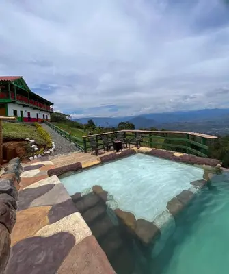 a swimming pool in the middle of a body of water at Finca Hotel Isla del Encanto in Támesis