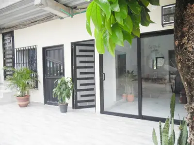 a front door of a building with potted plants at Apt#202 Descanso familiar en apartamentos vacacionales Bethel in Doradal