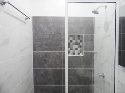 a shower with a glass door in a bathroom at Apt#202 Descanso familiar en apartamentos vacacionales Bethel in Doradal