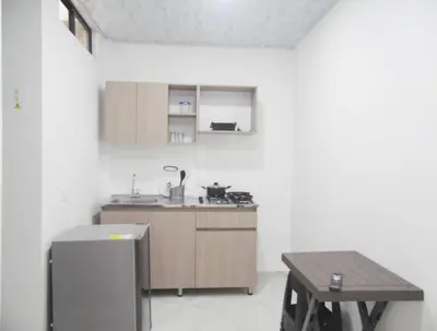 a kitchen with a sink and a table in it at Apt#202 Descanso familiar en apartamentos vacacionales Bethel in Doradal